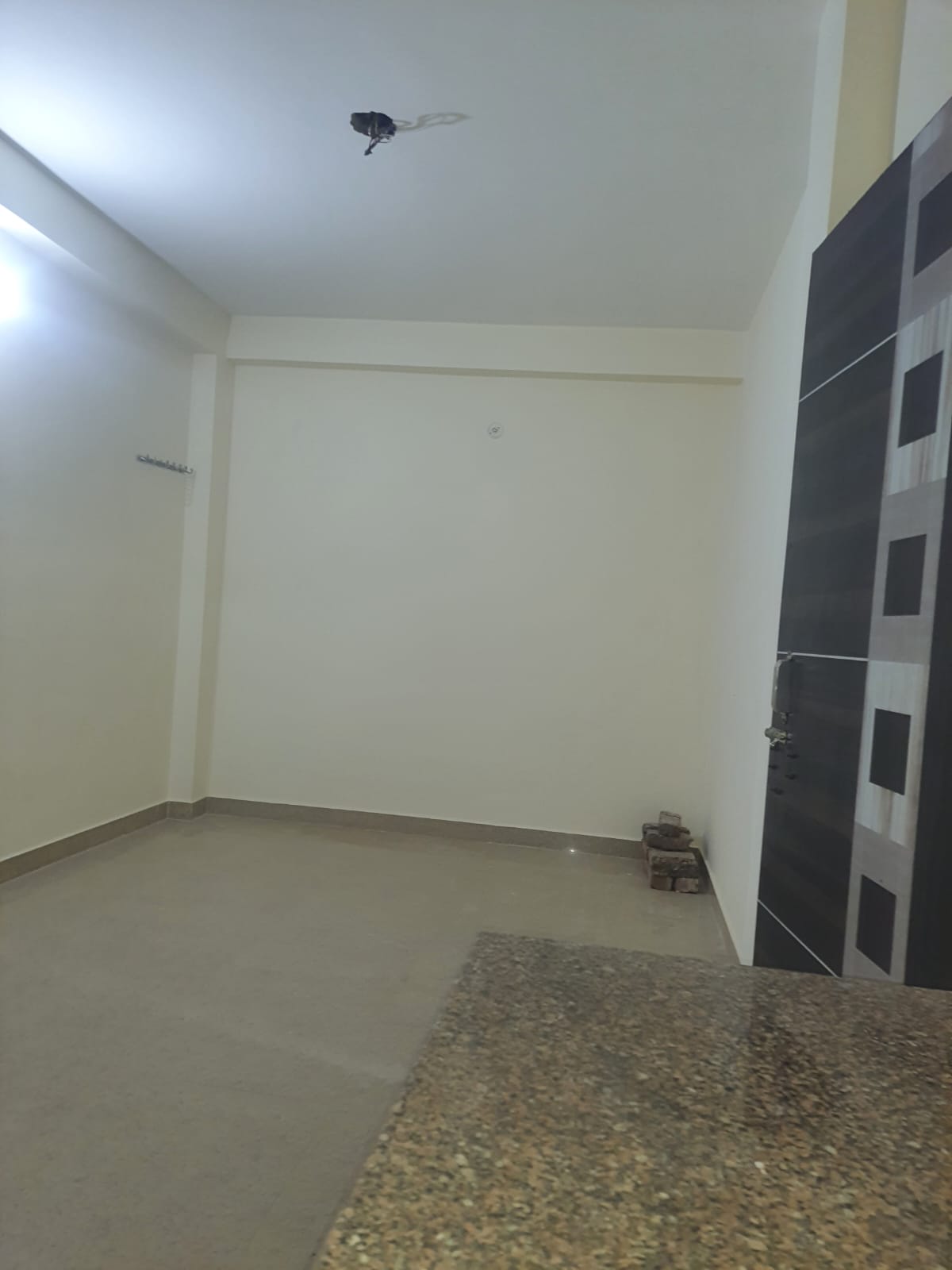 Affordable room for rent in Deoli South Delhi living area.